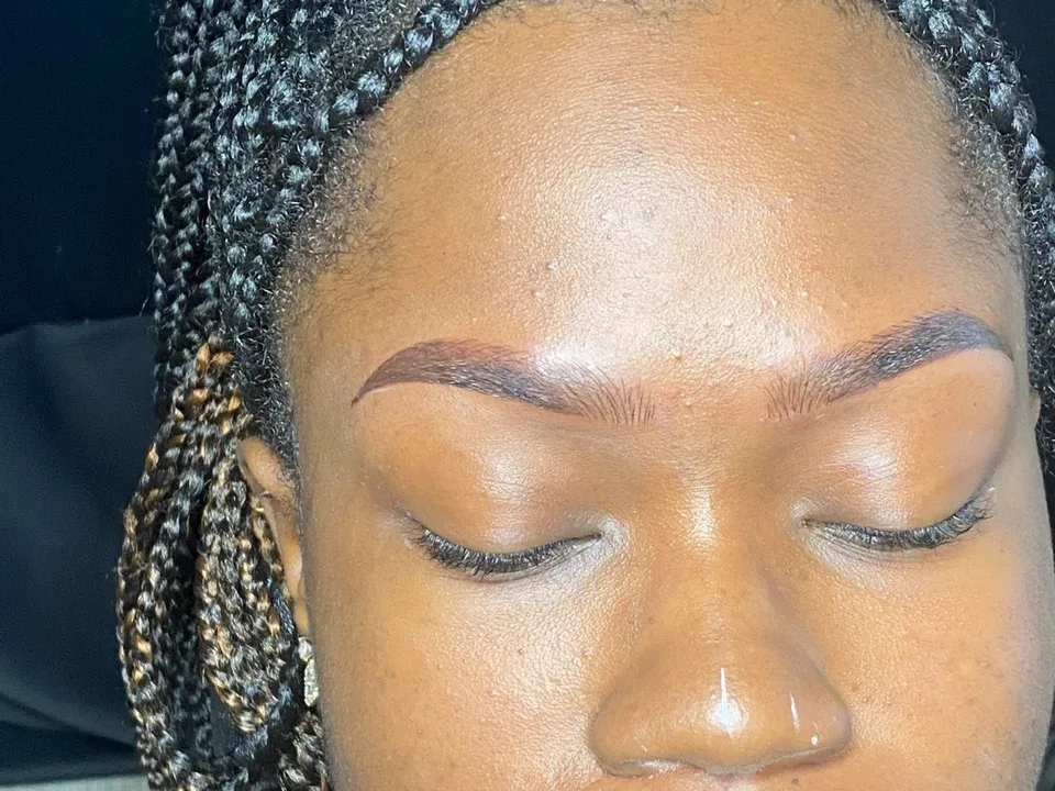 A pair of brows shaped and tinted into a clean, defined arch