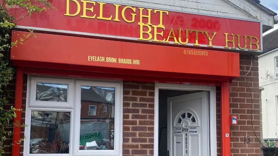 The red shopfront of Delight Beauty Hub, signed for eyelashes, brows, braids and wigs