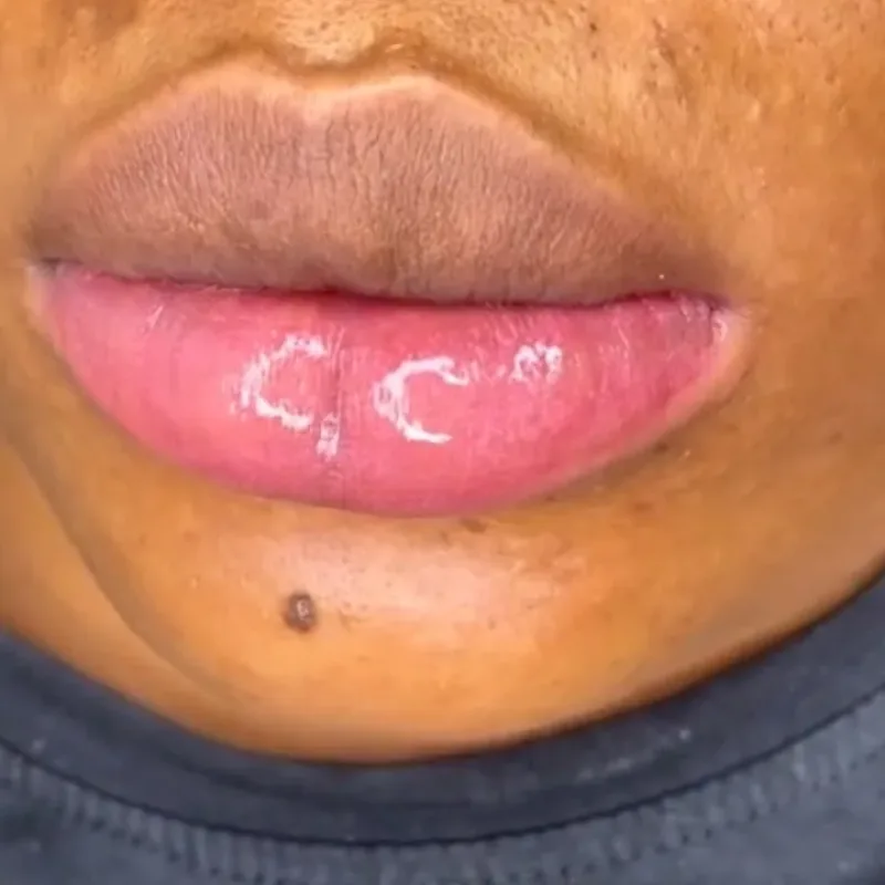 A client at Delight Beauty Hub with a finished lip tint