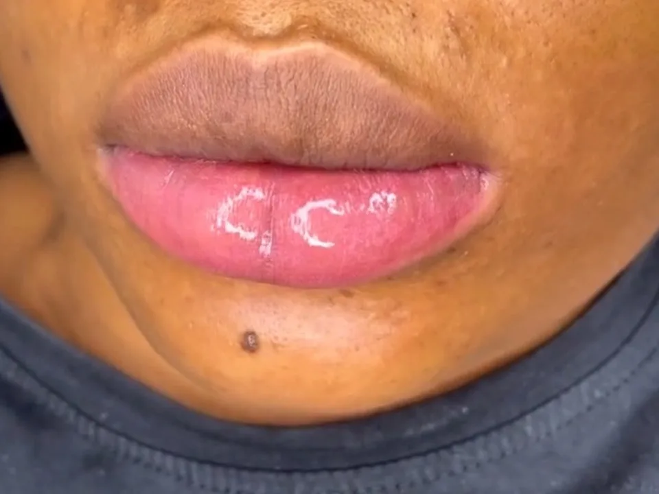 Lips finished with a glossy pink tint