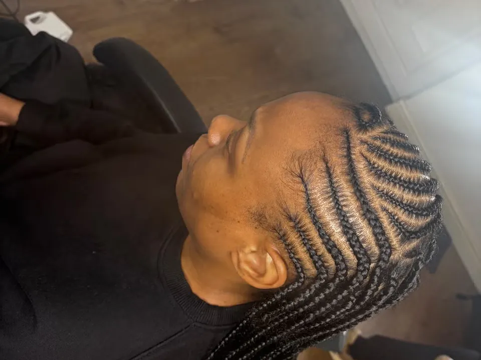 Straight-back feed-in braids being completed at the styling chair